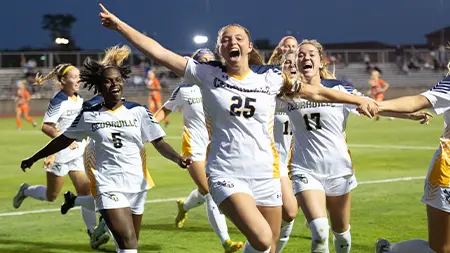 Women's soccer team celebrates victory on the field
