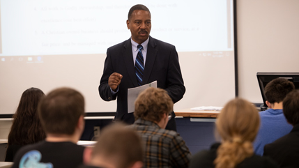 Dr. Patrick Oliver presenting in a classroom