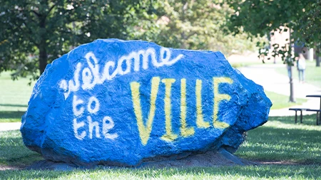 Rock painted with the words "Welcome to the Ville"