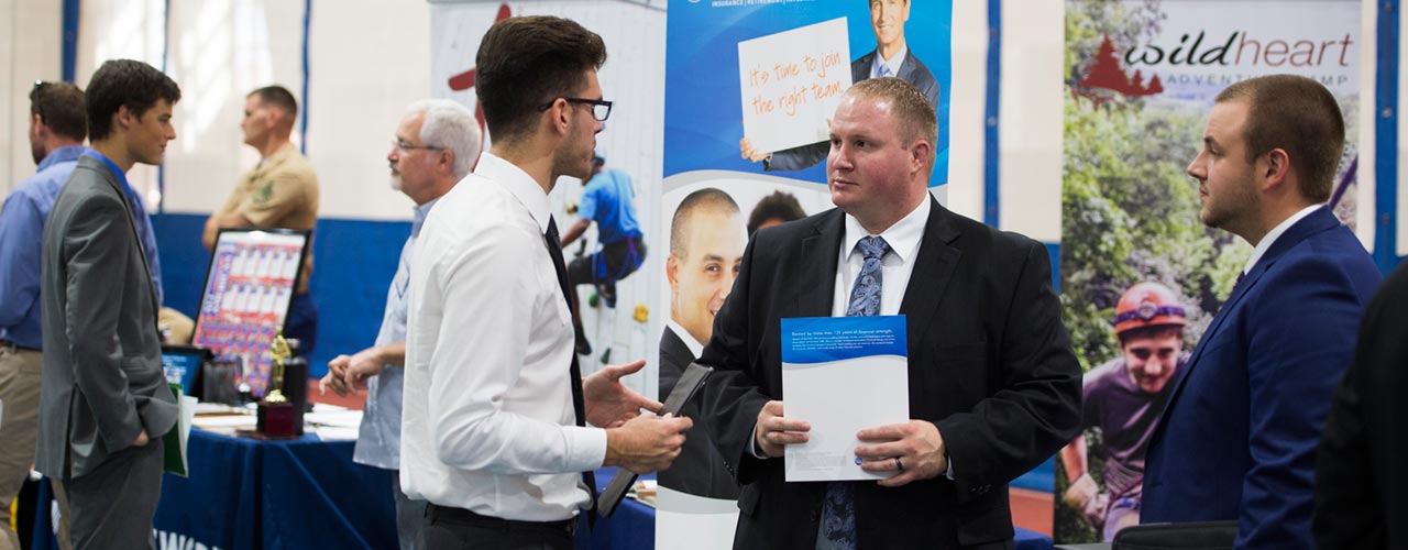 Students talk to recruiters during career fair