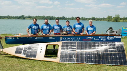 Solar splash team poses with boat