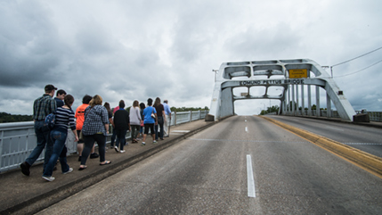 A group from Cedarville University walks across the Edmund Pettus Bridge in Selma, Alabama.