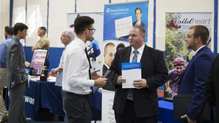 Student talks with recruiters during past fall career fair