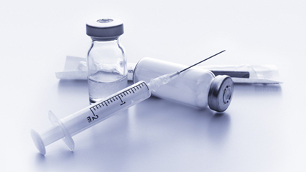 Picture of syringe and vaccine bottle.