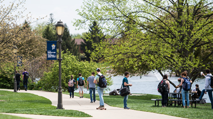 Students walk near Cedar Lake on campus of Cedarville University