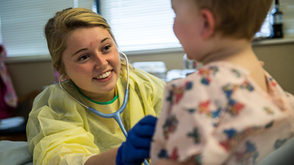 Cedarville nursing student works with pediatric patient