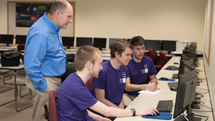 Cedarville student programmers work with professor