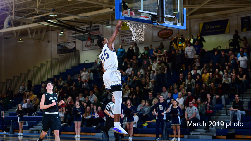 Cedarville men's basketball player dunking during a game against Lake Erie College in March 2019