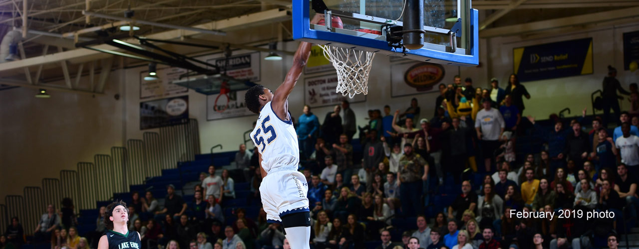 Cedarville men's basketball player dunking in a game against Lake Erie College in March 2019