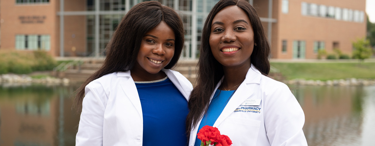 Current Cedarville University Pharmacy students Gloria Aboagye (left) and Abena Mpere (right) celebrate receiving their White Coats in 2019