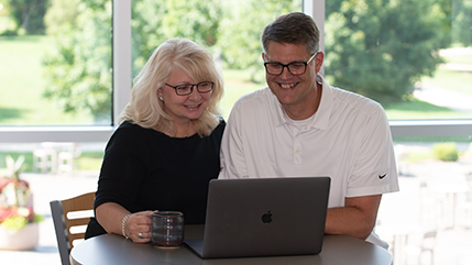 Cedarville parents looking a laptop computer
