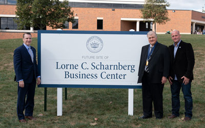 Dr. White, Lorne Scharnberg and Mark Scharnberg next to the new business center location