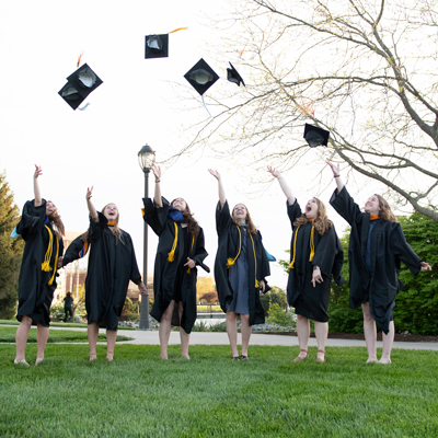 Students tossing their mortar boards in the air
