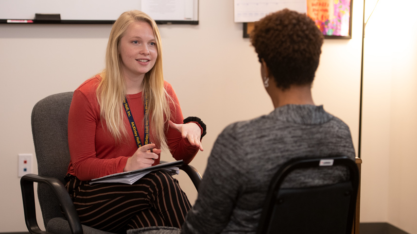 A social work student meets with a client