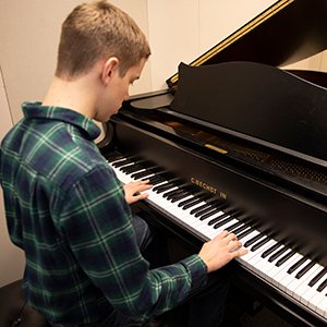 Male student playing piano