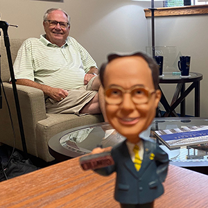 Dr. Paul Dixon with Paul Dixon bobblehead in foreground