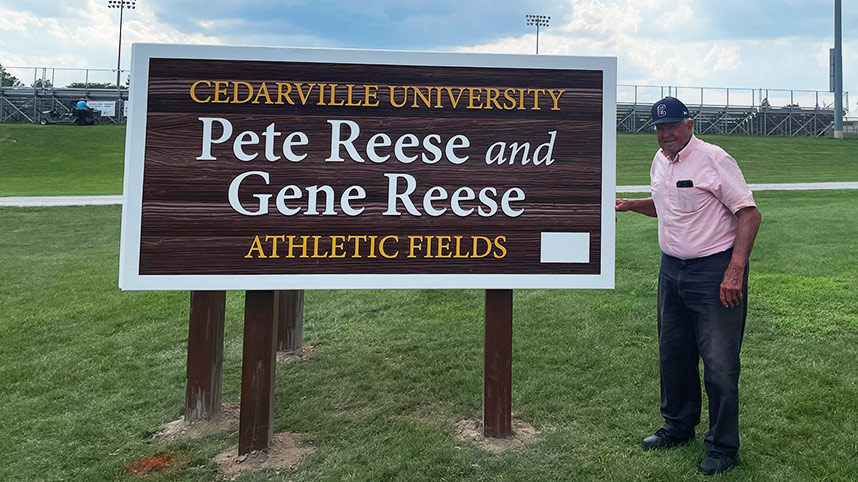 Pete Reese standing next to the new Pete Reese and Gene Reese Athletic Fields sign