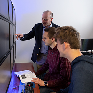 Dr. Seth Hamman meets with students in the cyber lab