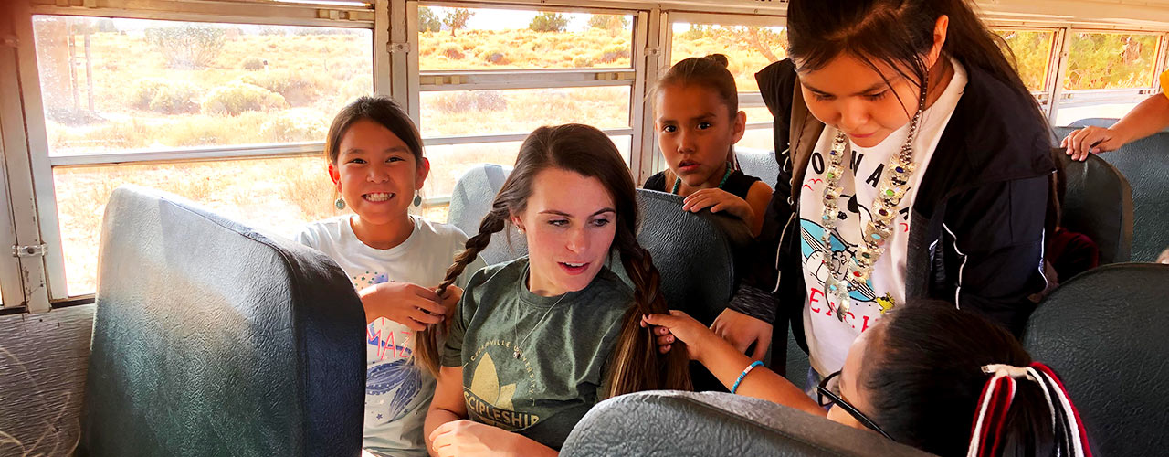 A Discipleship Council member traveling on a school bus with Immanuel Mission kids