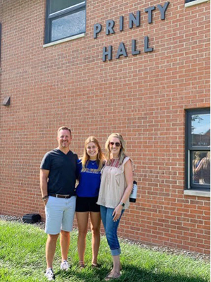 Jason, Courtenay, and Kylie Atwell standing outside Printy Hall.