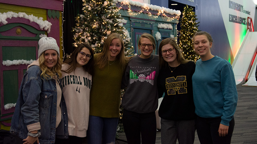 Six female students standing in front of the decorations in the Stevens Student Center.