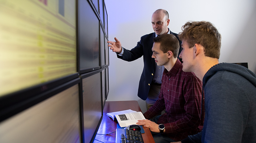 Dr. Seth Hamman instructing students in the cyber lab.