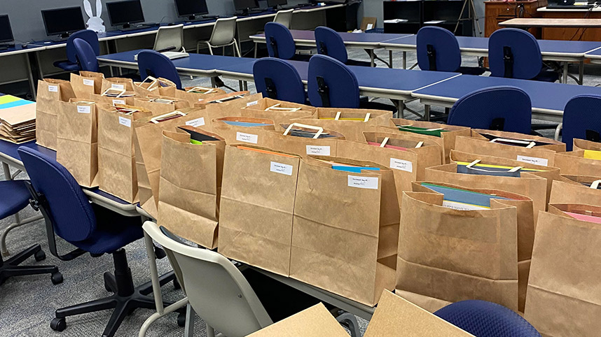 Enrichment bags for Cedar Cliff Elementary lined up on a table.