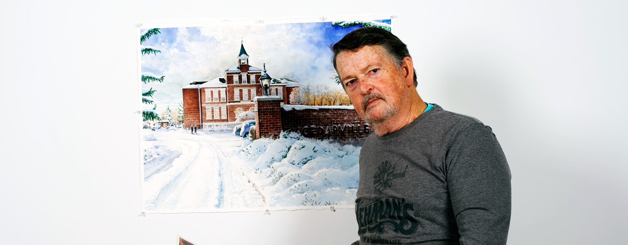 Dr. Chuck Clevenger posing with his painting of Founders Hall