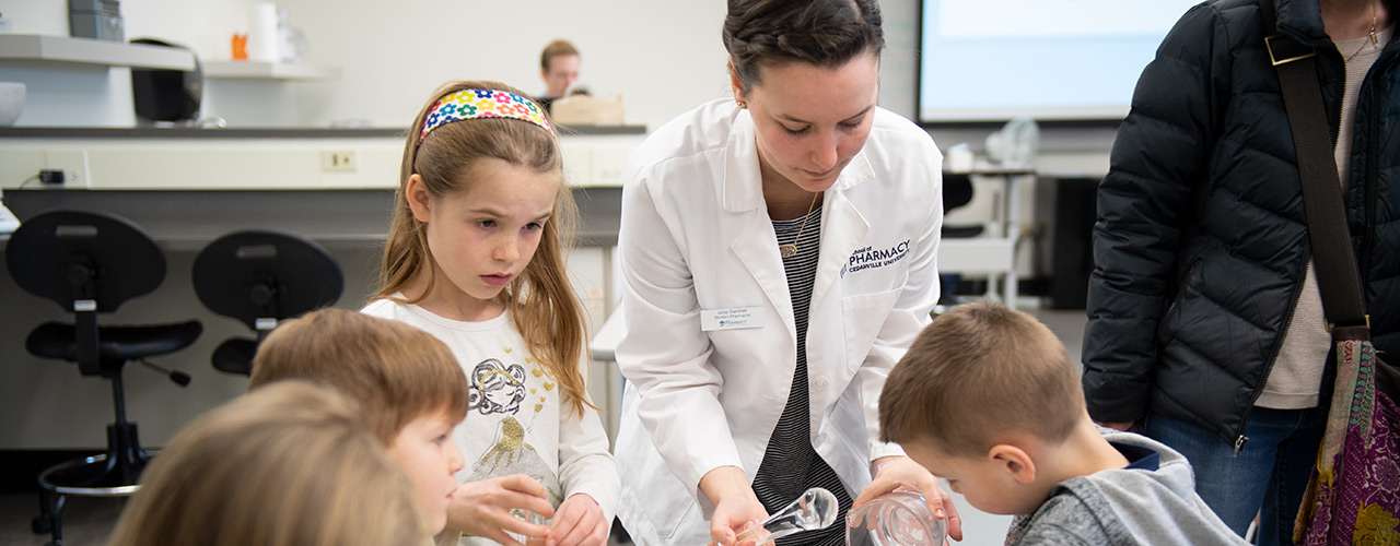 Homeschool students learning from a pharmacy student in 2018