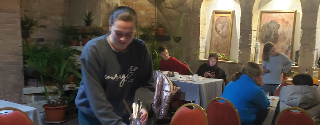 Leah Harper prepares a table at the hotel's restaurant for incoming Ukrainian refugees