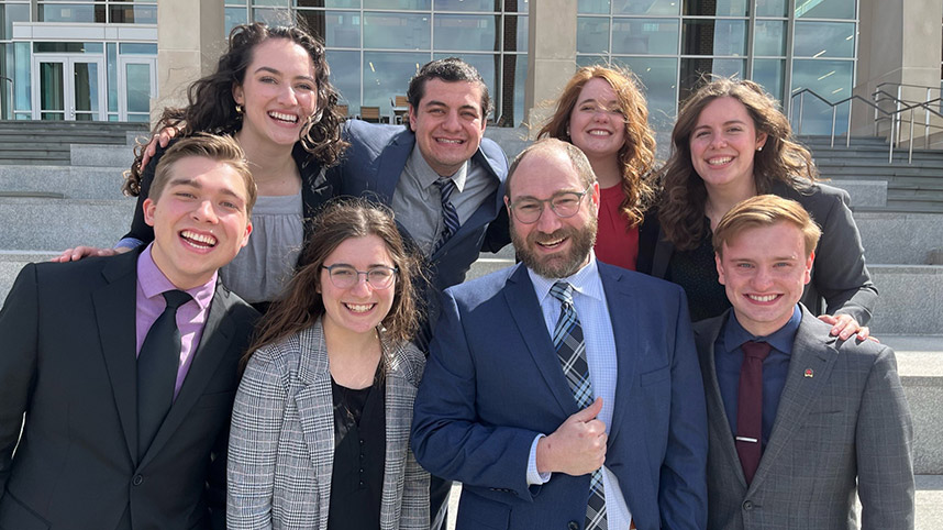 Professor Eric Mishne and the speech and debate team at the Christian college national competition 2022