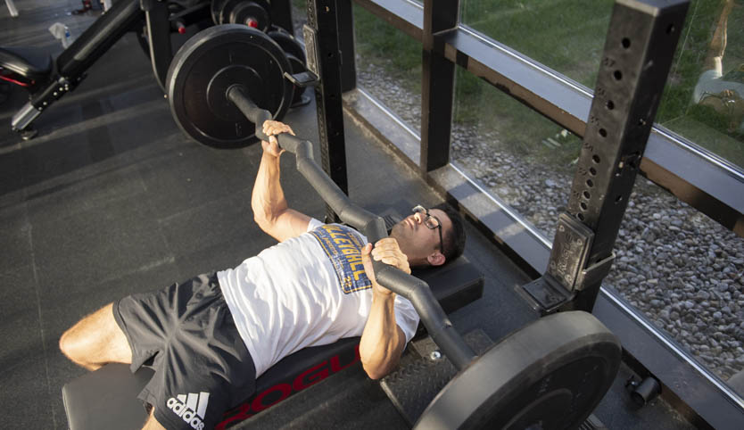 Man using Dr. Peterson's new barbell for shoulder stability