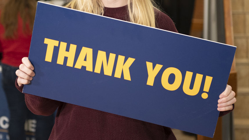Cedarville student holding thank you sign for donors