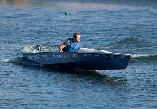 Student pilots the Cedarville Solar Boat prior to the Solar Splash competition.