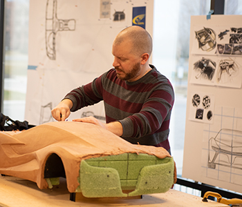 And Industrial and Innovative Design student working on a model of a car