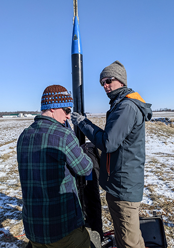 Forrest Putnam and Chad Sanderson prepare for the launch of their full-scale NASA Launch Team rocket in March 2022