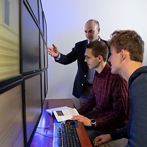 Dr. Seth Hamman instructs two cyber students