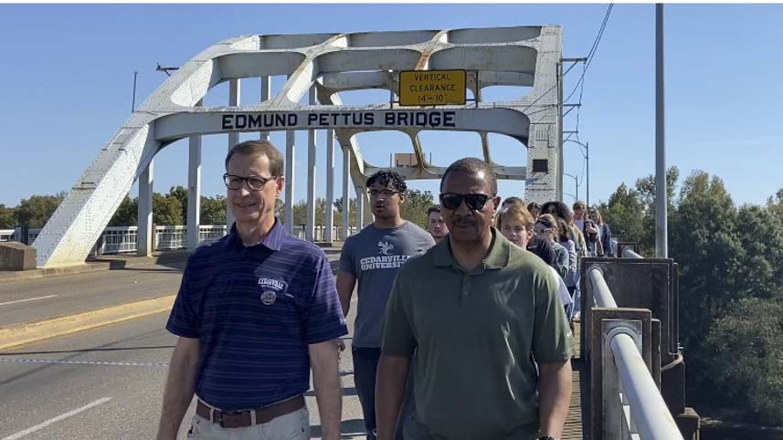Dr. Clark and Dr. Oliver walking students across the Edmund Pettus Bridge.