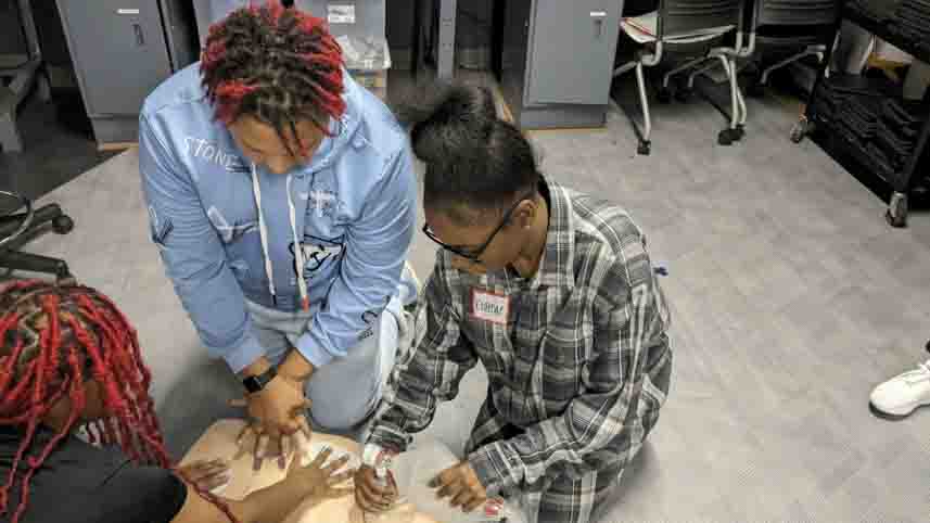 DECA high school students practice the skills they learned at a health professions event taught by Cedarville University students.