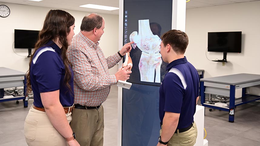 Dr. Mike Weller instructs his students in his athletic training class.