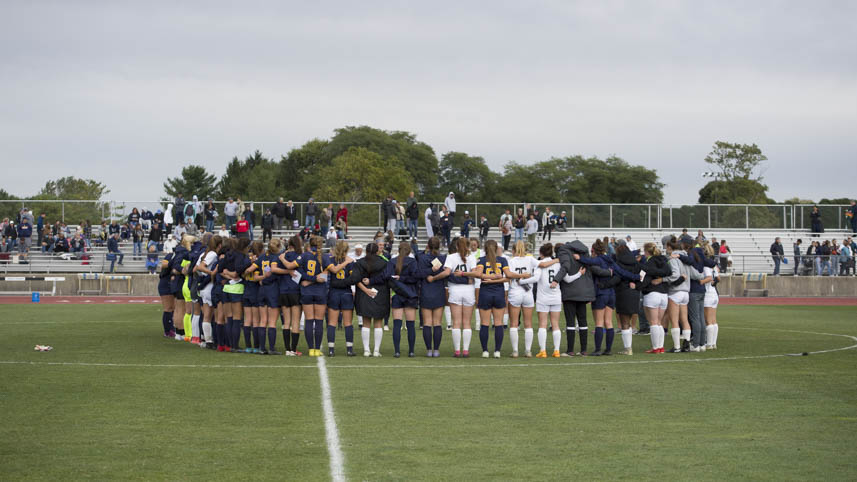 Cedarville University women's soccer team praying with opposing team.