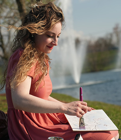 Aria Joy Prichard hand paints an illustration.