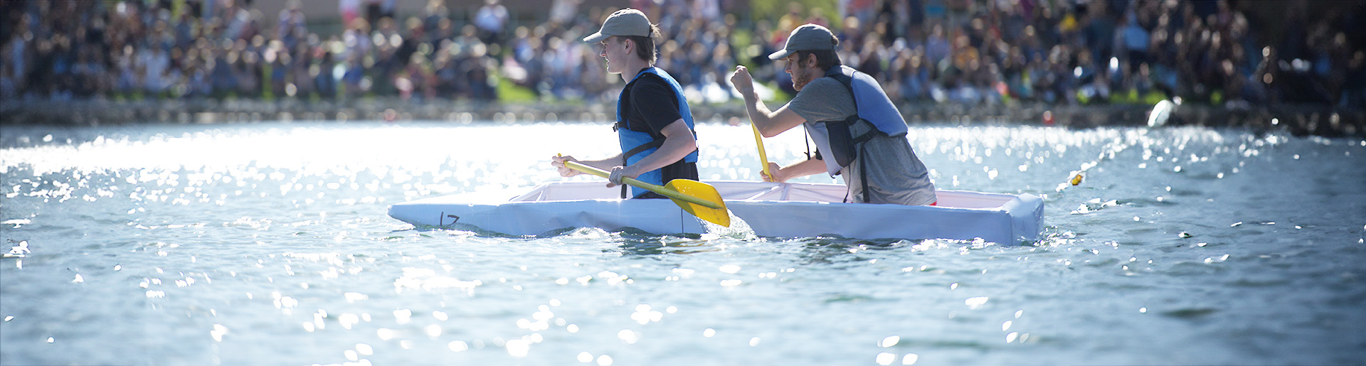 Students paddling a cardboard canoe on Cedarville University&#39;s Cedar Lake.