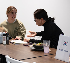 Dr. Kim teaches Korean over lunch in the Commons.