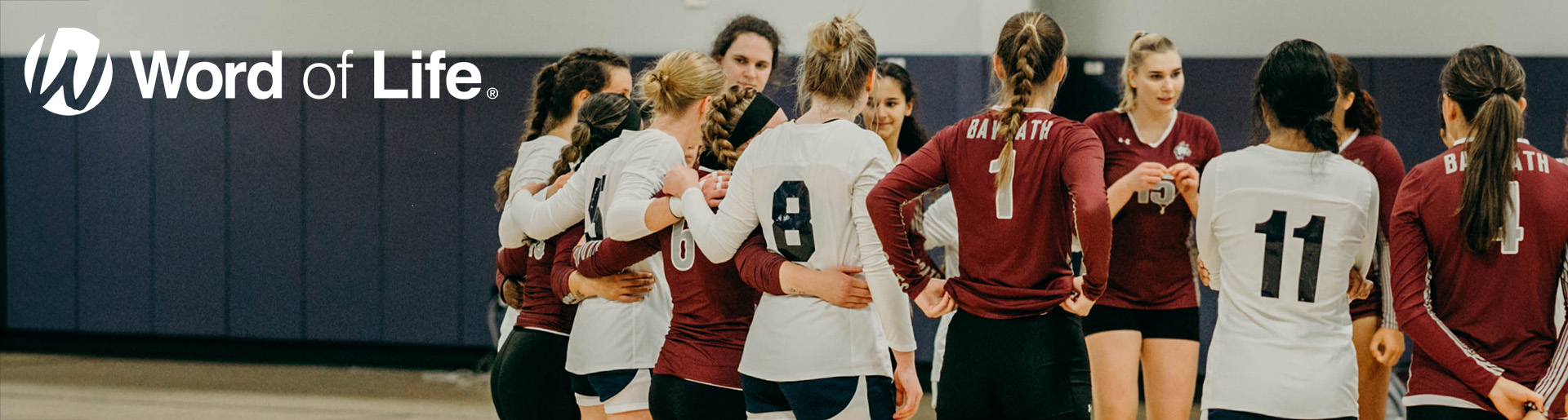 Word of life volleyball team praying with opponents.