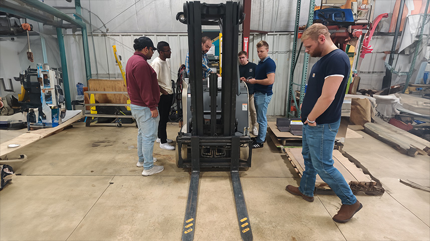 Crown fork truck with Cedarville University senior design team.