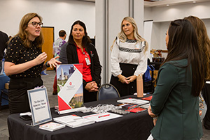 Student talking to graduate school at Healthcare Career Fair.