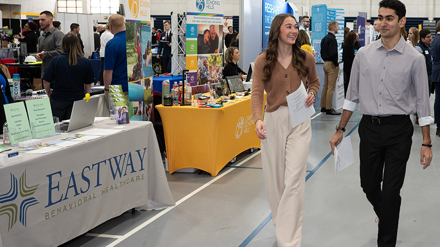 Students walking by booths at Healthcare Career Fair.