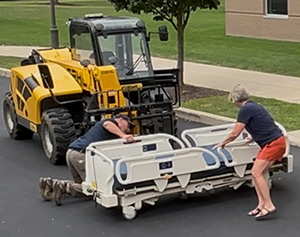 Loading donated hospital beds for transport to Advocates for World Health in Florida.