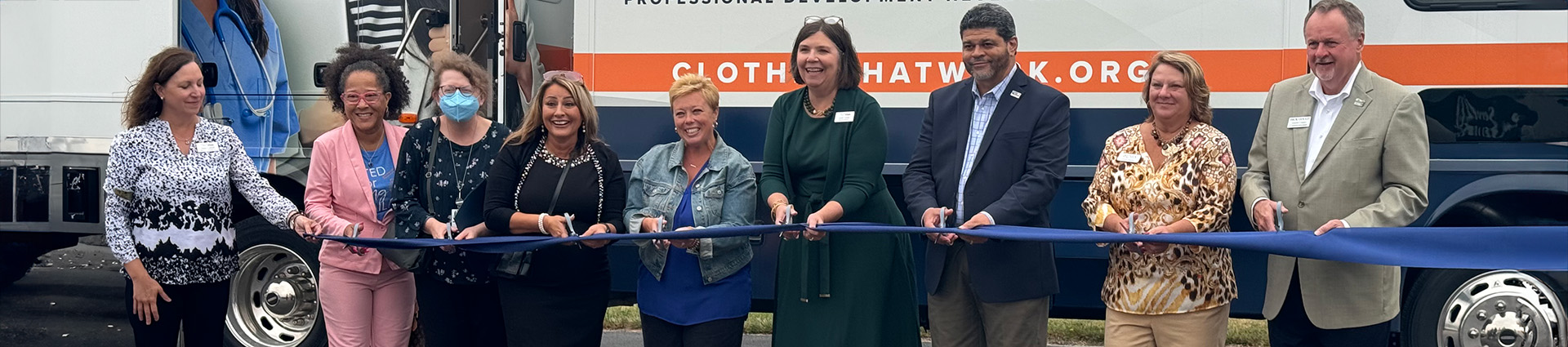Sarah Mays and other local leaders cut the ribbon at the opening of Clothes That Work.